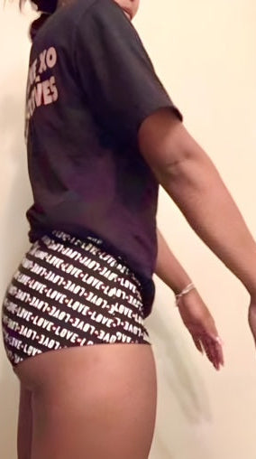 Two people wearing shorts with a repeated pattern on a plain background