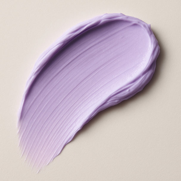Purple smear of cream on a beige background