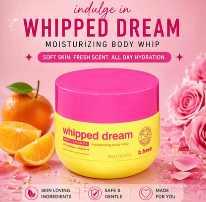 Yellow and pink jar of 'Whipped Dream' moisturizing body whip with oranges and roses on a pink background