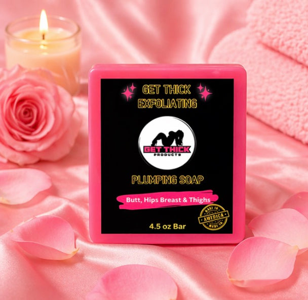 Pink soap bar with 'Get Thick' branding on a pink fabric background with roses and a candle.