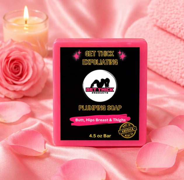 Pink soap bar with 'Get Thick' branding on a pink fabric background with roses and a candle.